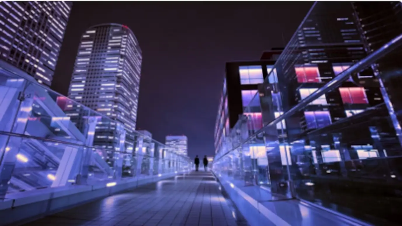 Modern city buildings at night representing urban E-Band wireless transport